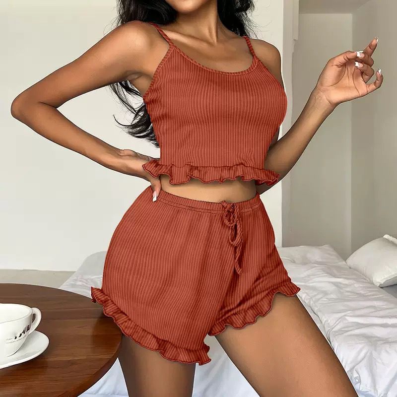 Rust-colored ribbed tank and shorts pajama set with ruffle hem, ideal for cozy loungewear and sleepwear.