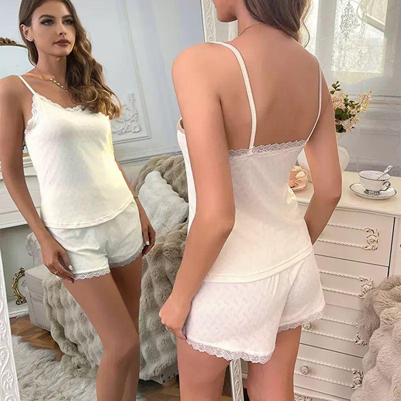 White lace-trimmed lounge set from The Aria Romantique, featuring a cami top and shorts with delicate lace. Seductress Beauty elegant nightwear.